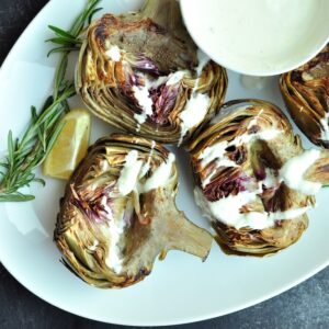 Perfectly tender sous vide artichokes complemented by a creamy yogurt sauce made with the ingredients from the cooking bag.