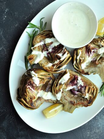 These beautifully tender sous vide artichokes are a versatile choice as either a sophisticated appetizer or a refined side dish for your main courses. Serve them with a homemade yogurt dipping sauce—its creaminess and hint of zest complement the subtle, earthy flavor of the artichokes exquisitely.