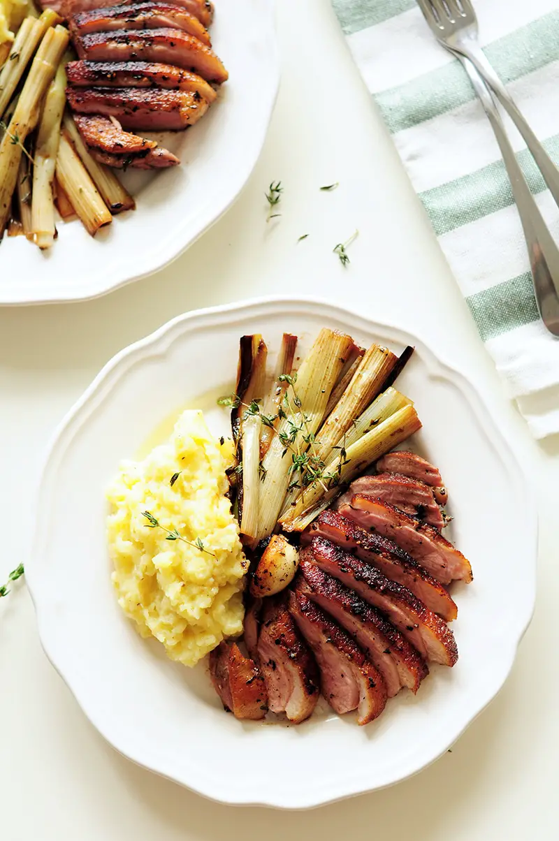 Juicy sous vide duck breast served with fluffy garlic mashed potatoes and braised leeks simmered in a white wine sauce. This date-night dinner is on point!