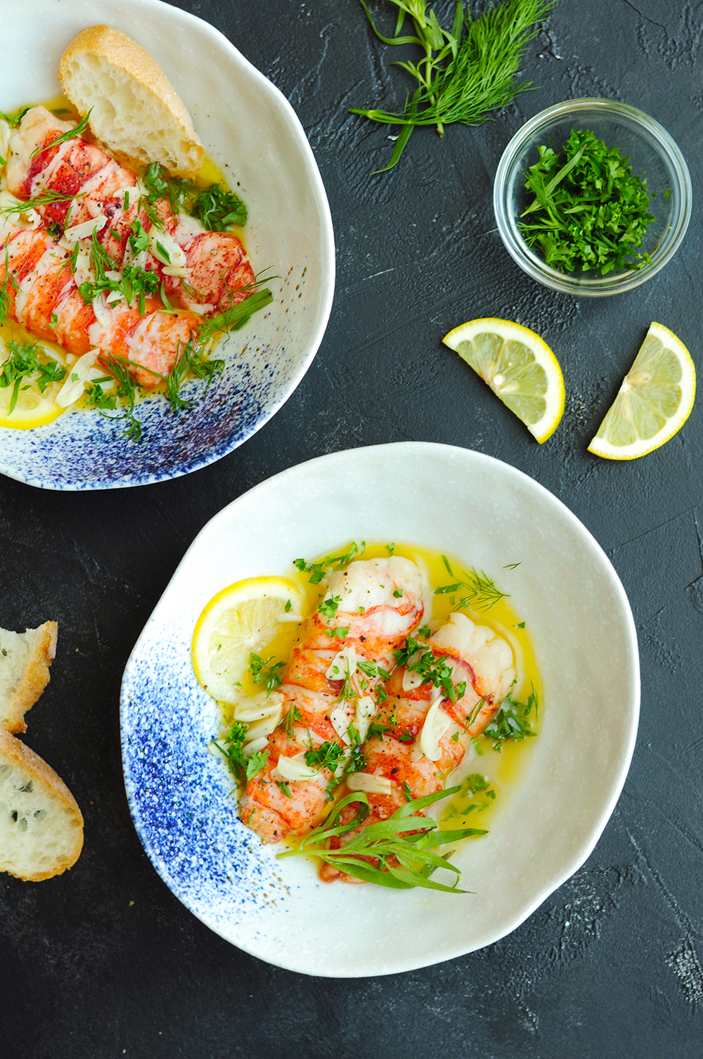 Sous vide lobster tails in shallow soup bowls