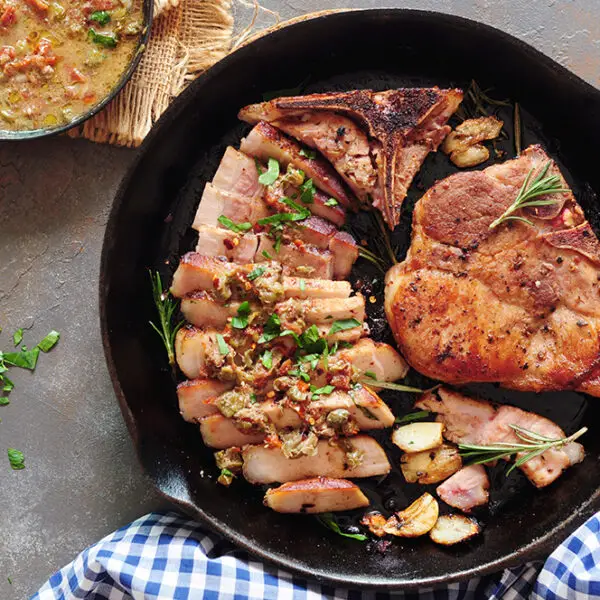 Sous vide pork chops in a cast iron skillet after searing