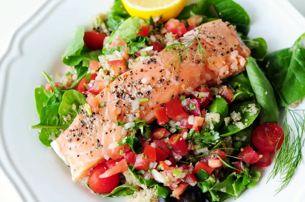 Sous vide salmon fillets with crispy skin paired with classic pico de gallo and a simple quinoa salad