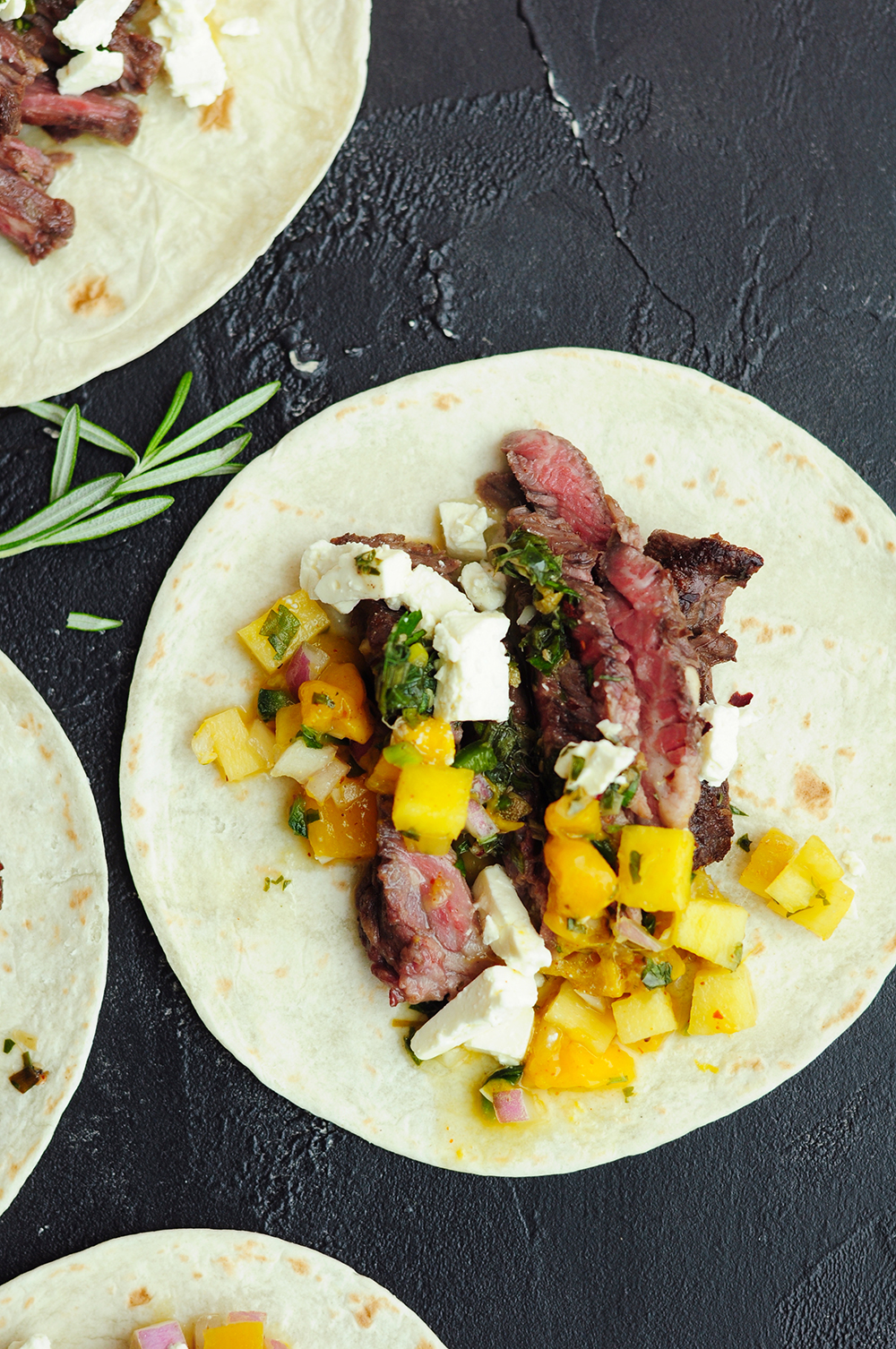 One skirt steak tacos with mango pico and feta