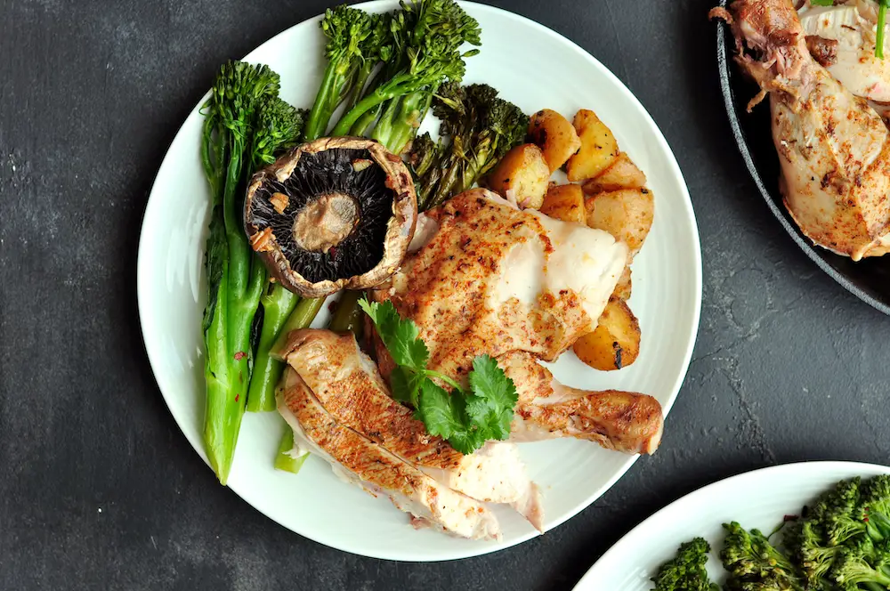 Sous vide whole chicken with garlic paprika sous vide potatoes and pan-steamed broccolini with portobello mushrooms