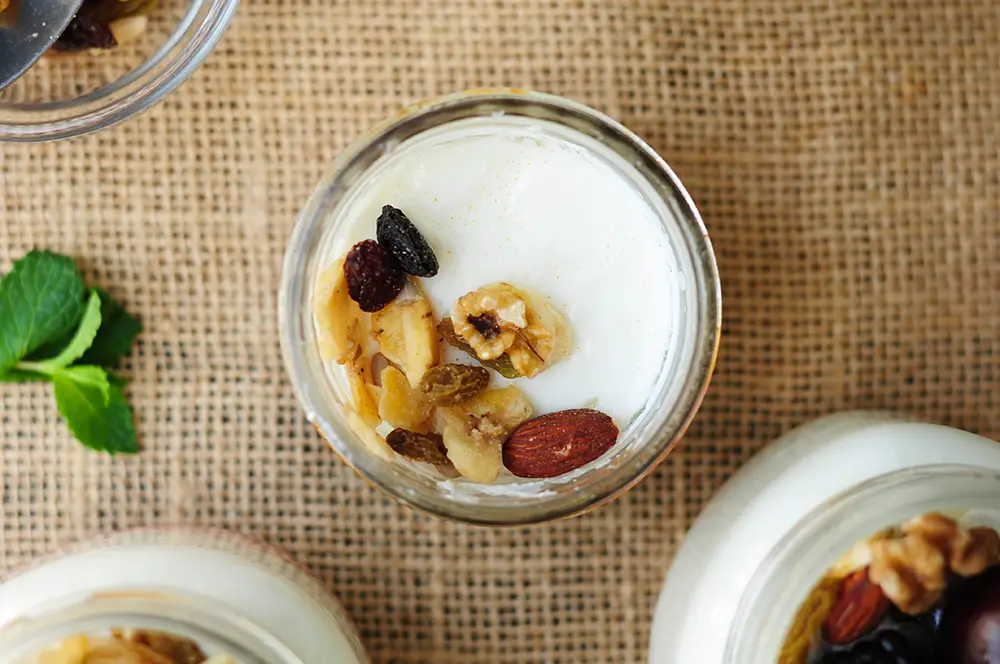 Sous vide yogurt in a jar topped with nuts
