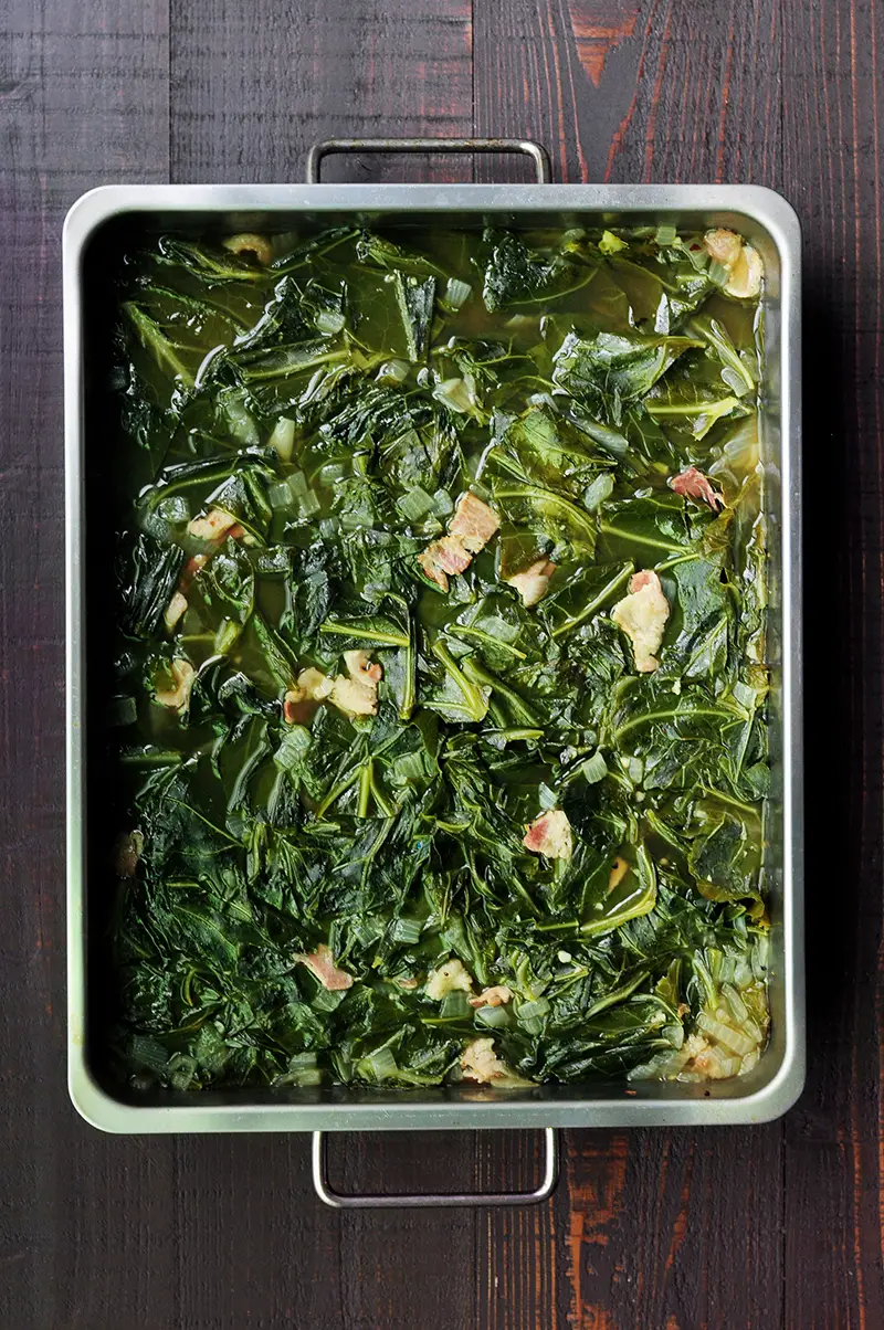 Easy and nutritious southern collard greens with bacon and bone broth slow cooked in the oven or on the stove. 