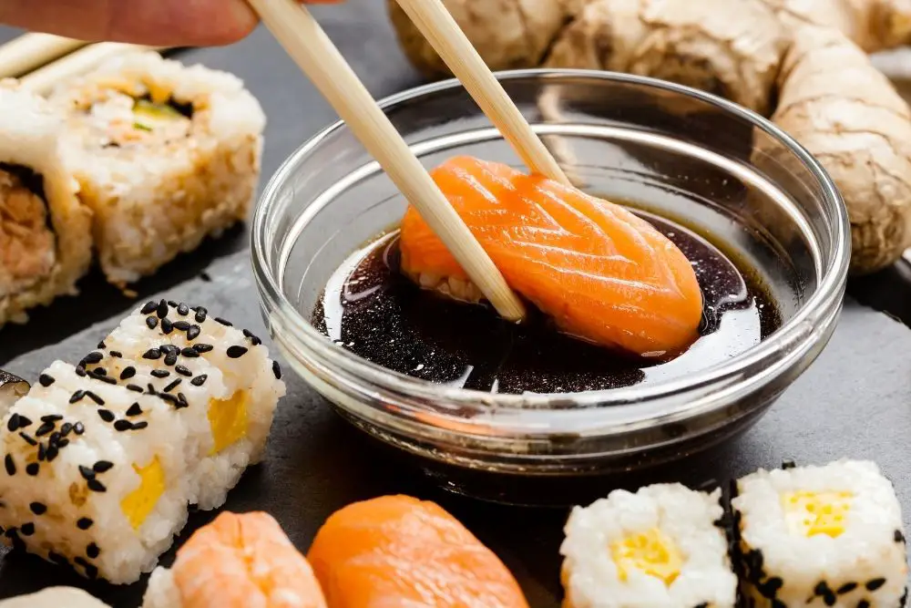 Dipping sushi in soy sauce