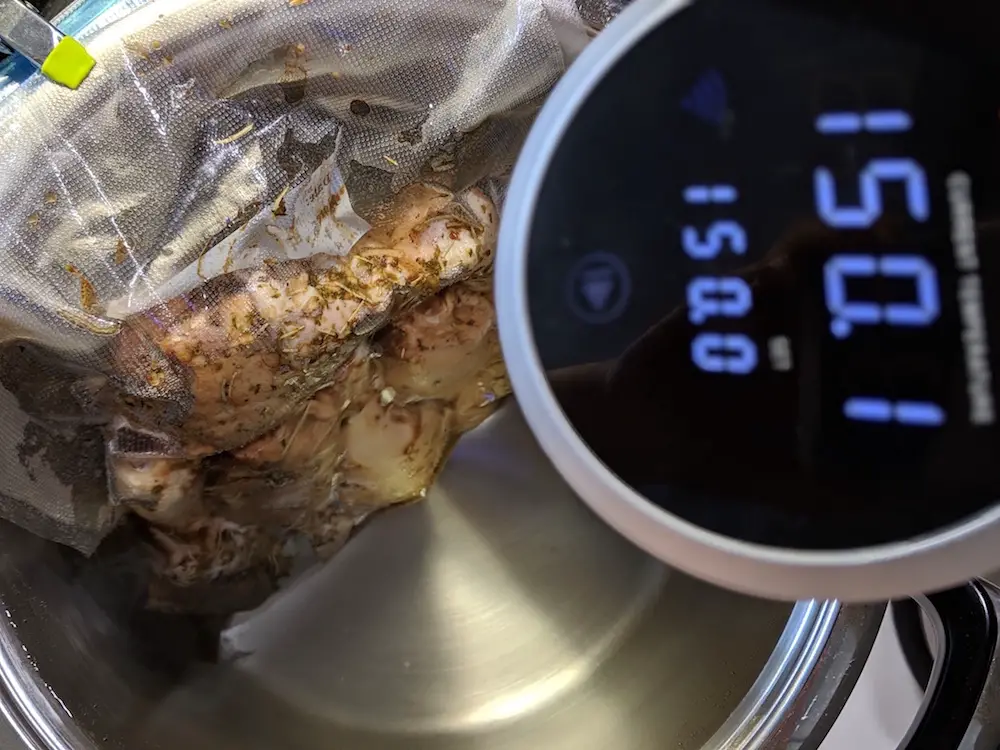 sous vide bag clipped to the side of a pot
