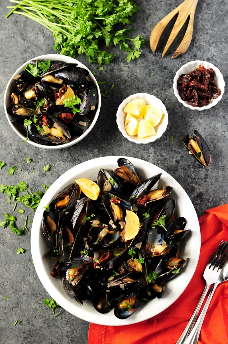 Super easy mussel recipe steamed in white wine and flavor-rich chicken bone broth. Serve it as an amazing appetizer or over spaghetti as an elegant dinner. 