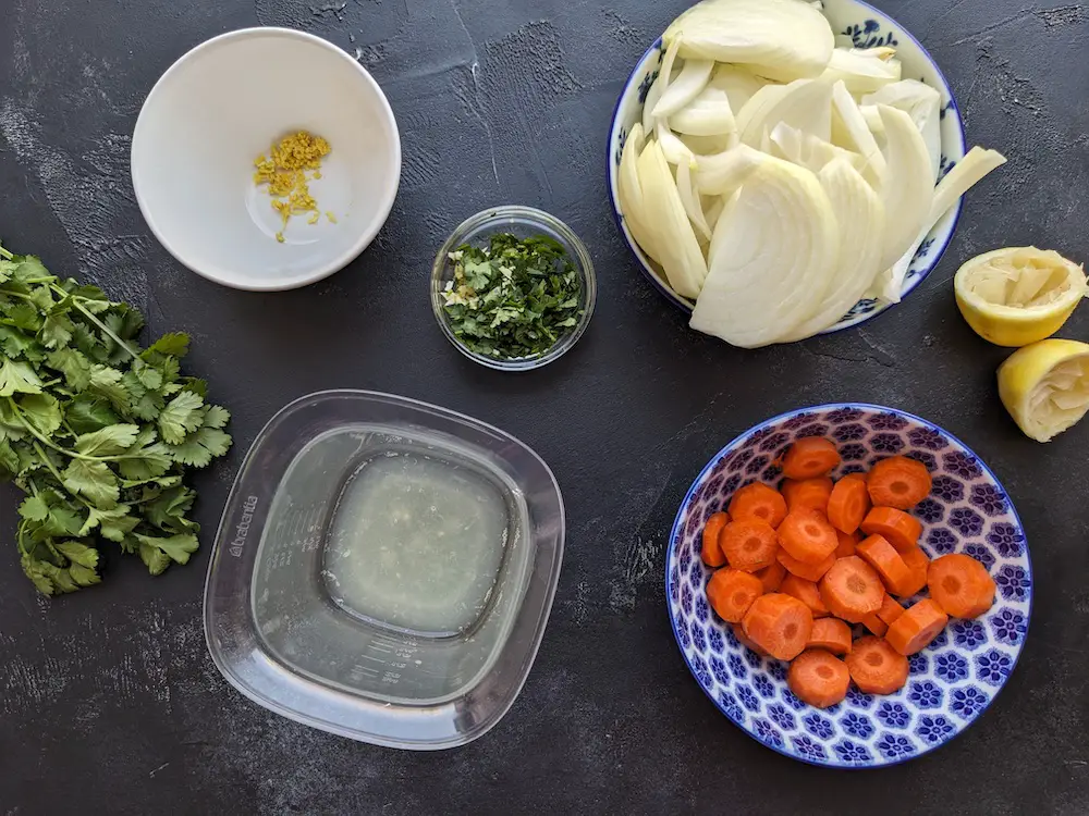 Chop onion and carrots; zest lemon and squeeze lemon juice; prepare olives and cilantro.