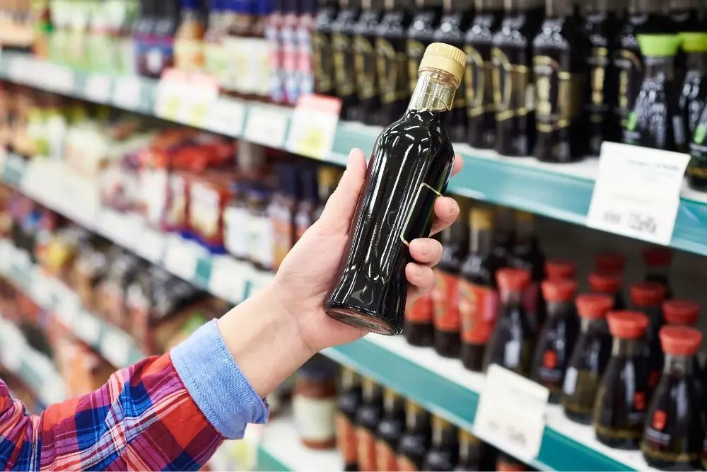 Someone holding a bottle of Tamari