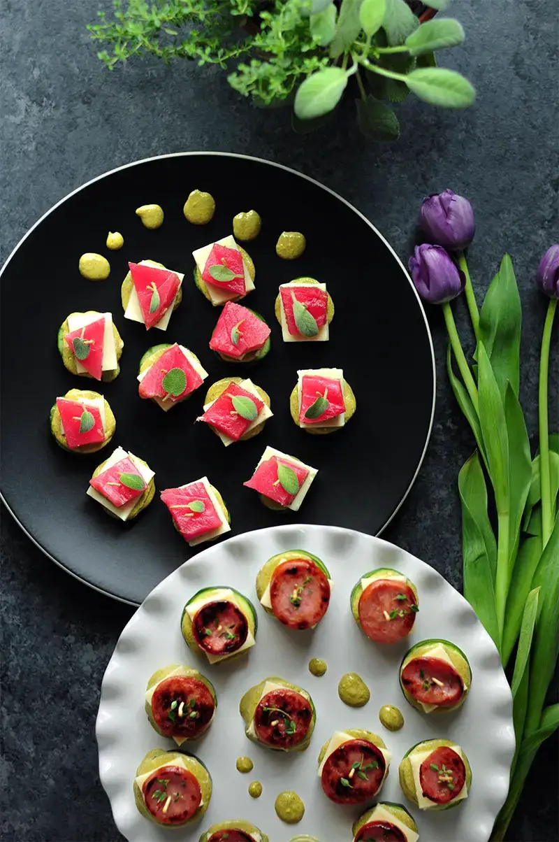 Tuna-cucumber stackers and sausage-zucchini stackers with the same sauce and cheese to please both seafood lovers and meat lovers in your family.