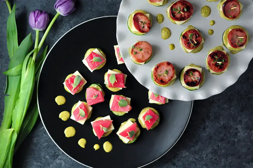 Tuna-cucumber stackers and sausage-zucchini stackers with the same sauce and cheese to please both seafood lovers and meat lovers in your family.