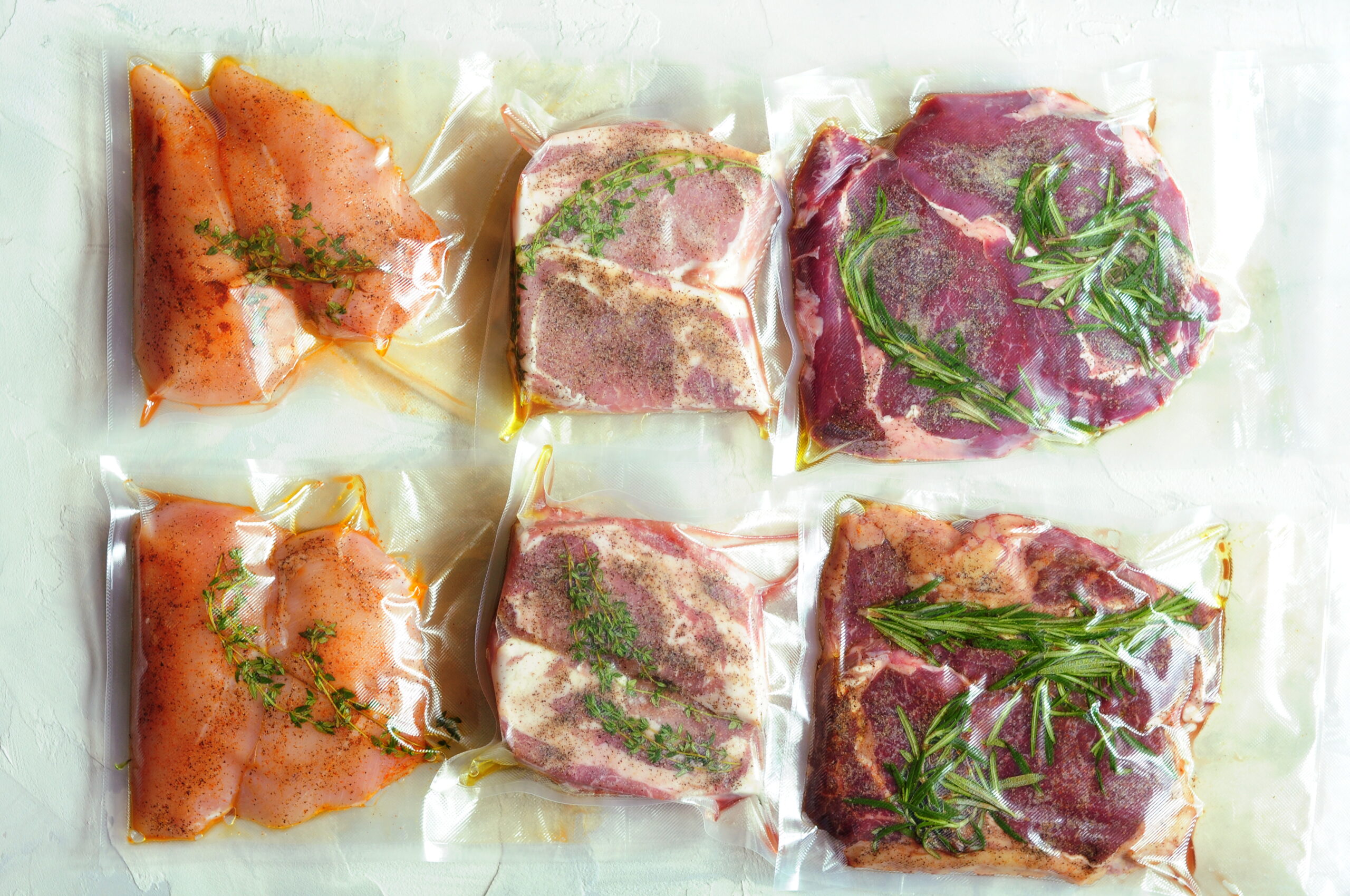 Vacuum-sealed chicken, pork and steak