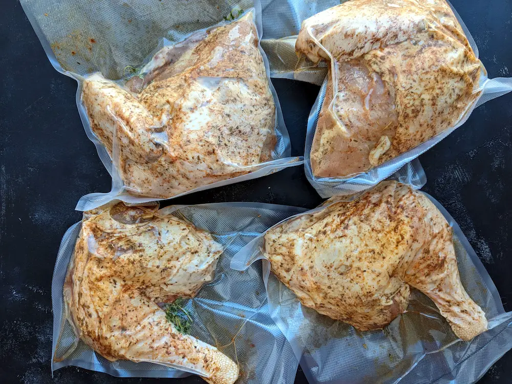Cut four cut-to-size vacuum-sealer bags from a vacuum-sealer roll. Put each part of the turkey into a separate bag, and add fresh herbs if you like. Vacuum seal the bags.