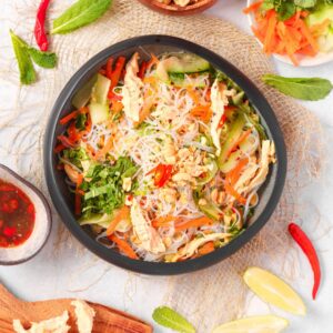Enjoy a vibrant Vietnamese Chicken Noodle Salad ready in 15 minutes! This high-protein meal features sous vide chicken, fresh herbs, and zesty Nuoc Cham dressing for a quick, healthy lunch.