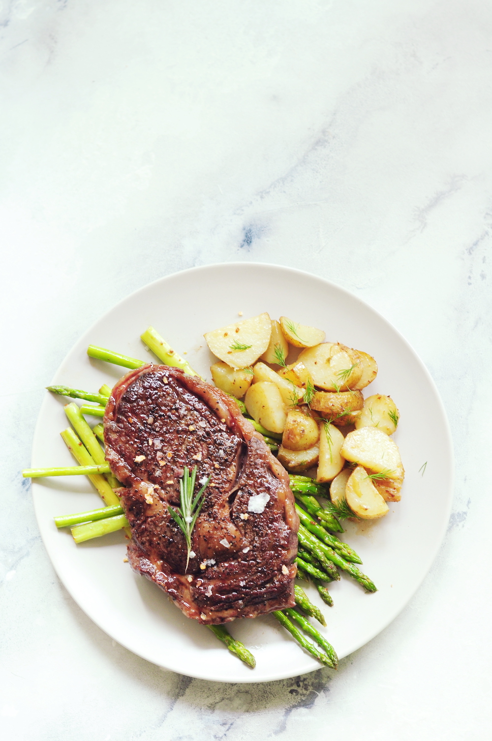 sous vide frozen steak with potatoes and asparagus